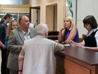 Guests at a hotel reception asking questions