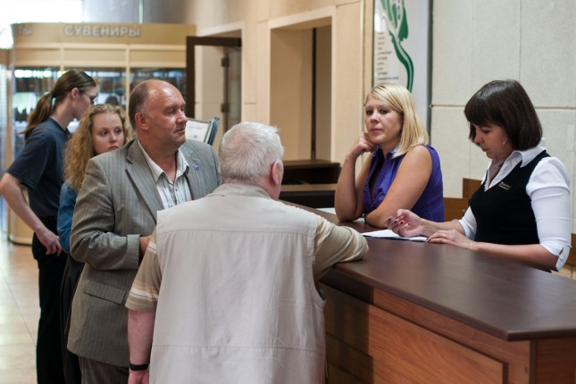 Guests at a hotel reception asking questions